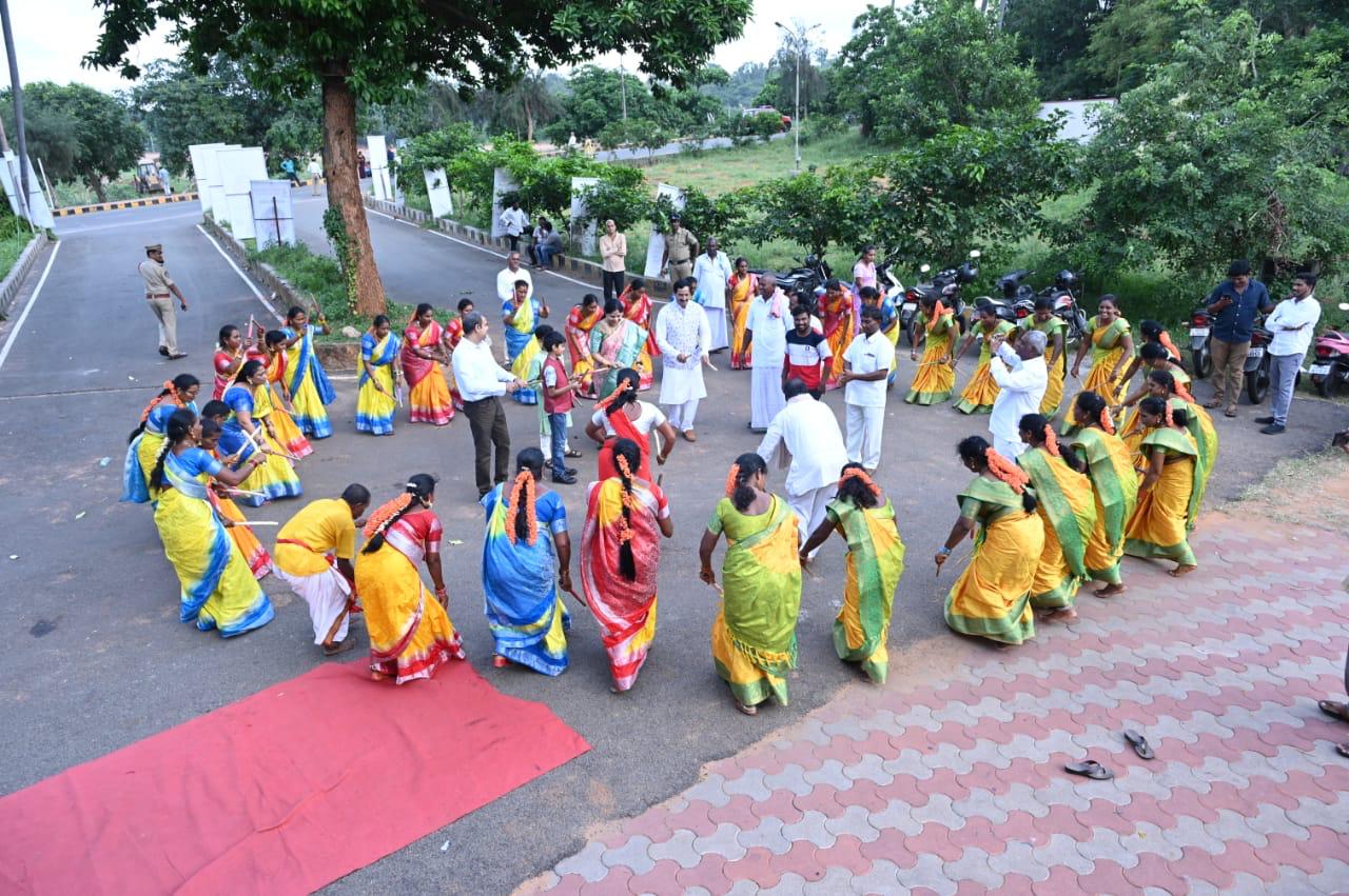 A ceremonial chariot procession with participants holding a rope