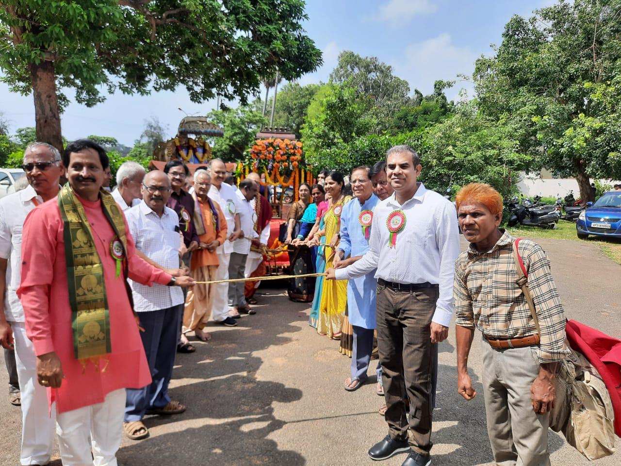 Participants gathered outdoors around a ceremonial chariot