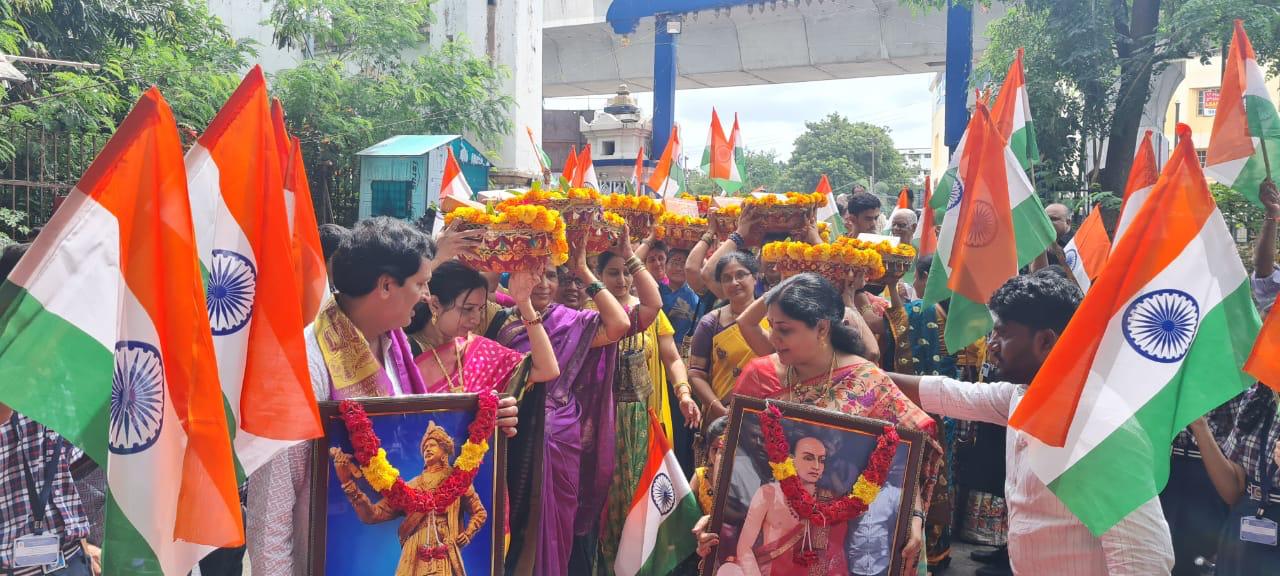 Participants carrying Indian flags during a cultural procession