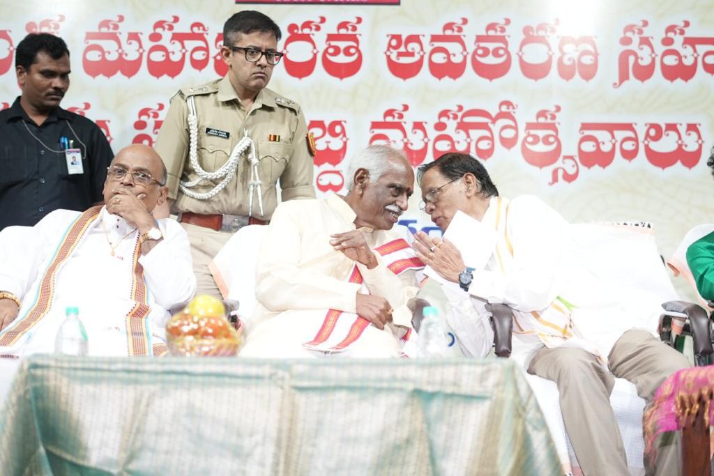 Panel of dignitaries seated on stage